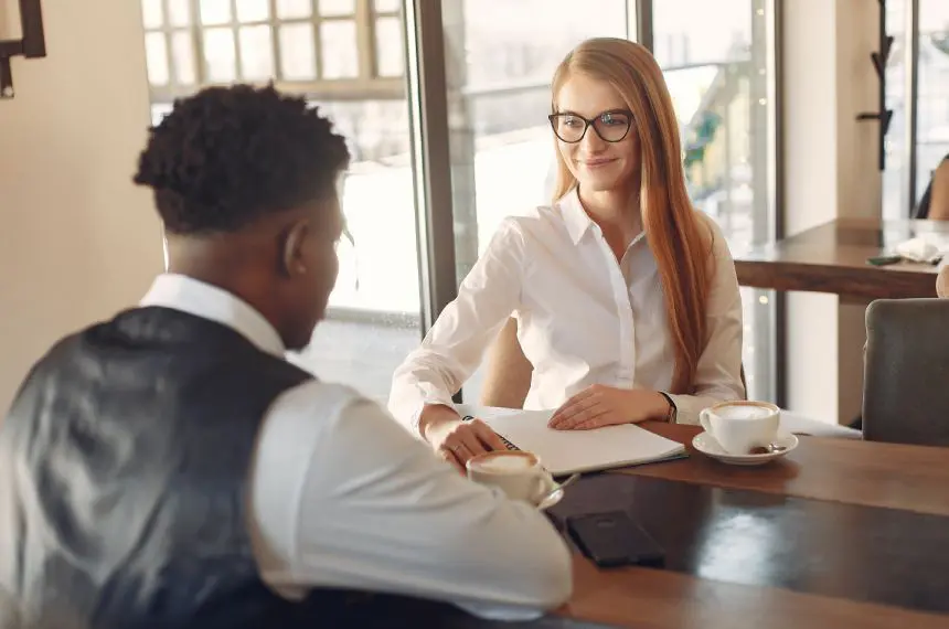 Two smiling business people working in a modern office