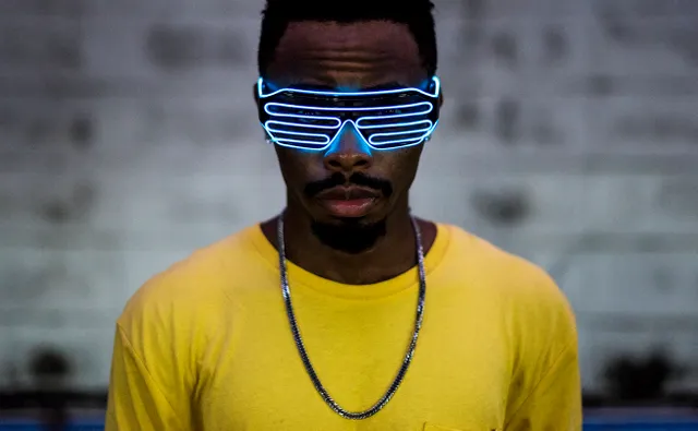 Young man wearing futuristic led glasses